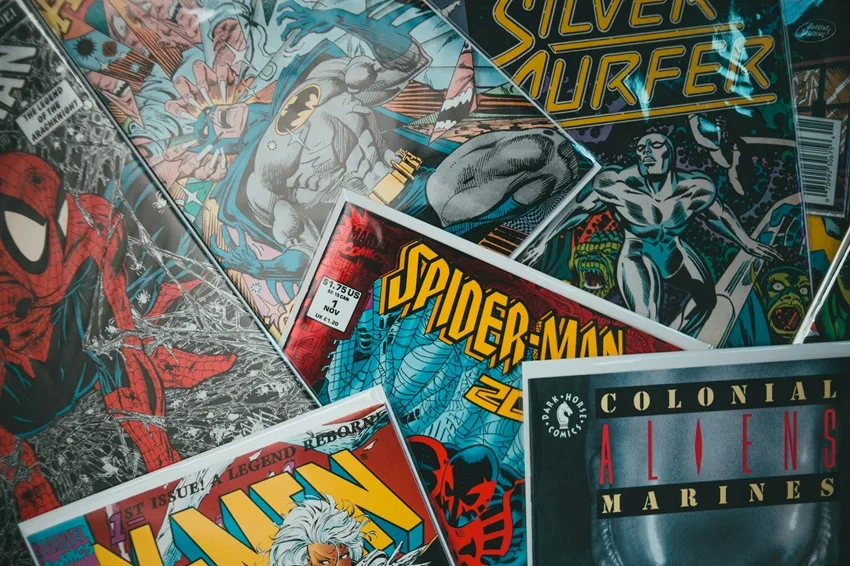 A pile of comic books on the floor. Photo by Erik Mclean.